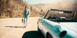 Sara is an Italian woman with a calm, natural presence. She is self-confident, clear-headed, and has a touch of rebellion about her. The setting was simple: dusty roads, an old Alfa, soft light, no big setup.